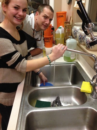 Caroline and Sam wash group dishes in the Depot at the Idaho campus