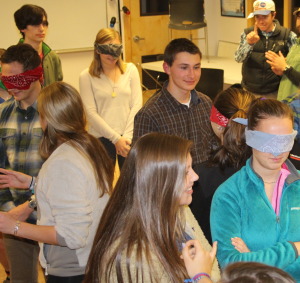 Students team up with blindfolded peers to guide them through activities 